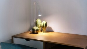 A wooden desk with three decorative vases and a modern desk lamp. - <p><strong>Near the lake and the center (FLORIDA ASCONA Room 11)</strong></p><p>Just a few steps from the center and the charming lakeside promenade of Ascona, FLORIDA ASCONA Room 11 welcomes guests into a refined and comfortable setting, ideal for disco (Ascona)