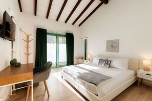 A bedroom with a bed, a desk, a chair, a TV, a window with curtains, and a wall art piece. - Near the lake and the center (FLORIDA ASCONA Room 15) (Ascona)