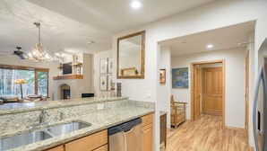 A modern kitchen with granite countertops, stainless steel appliances, and wooden cabinets. - Prime Location, Steps from the Ski Lift - 2 Bedroom Condo in Arrowhead Village 2 Condo (Edwards)