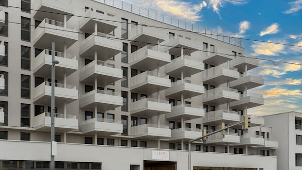 A modern multi-story building with balconies, a visible entrance, and a sign reading "OLIVER palace". - OLIVER pulse I Self check-in Apartments (Vienna)