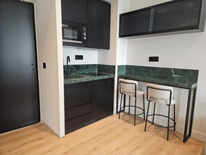 Mini-fridge, microwave, stovetop, cookware/dishes/utensils