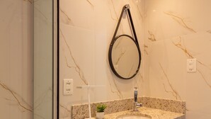 A modern bathroom with a glass shower enclosure, a marble wall, a granite countertop, a sink with a mirror, and recessed ceiling lights. - 5 Minutes From Copacabana Beach Bi202 (Rio de Janeiro)