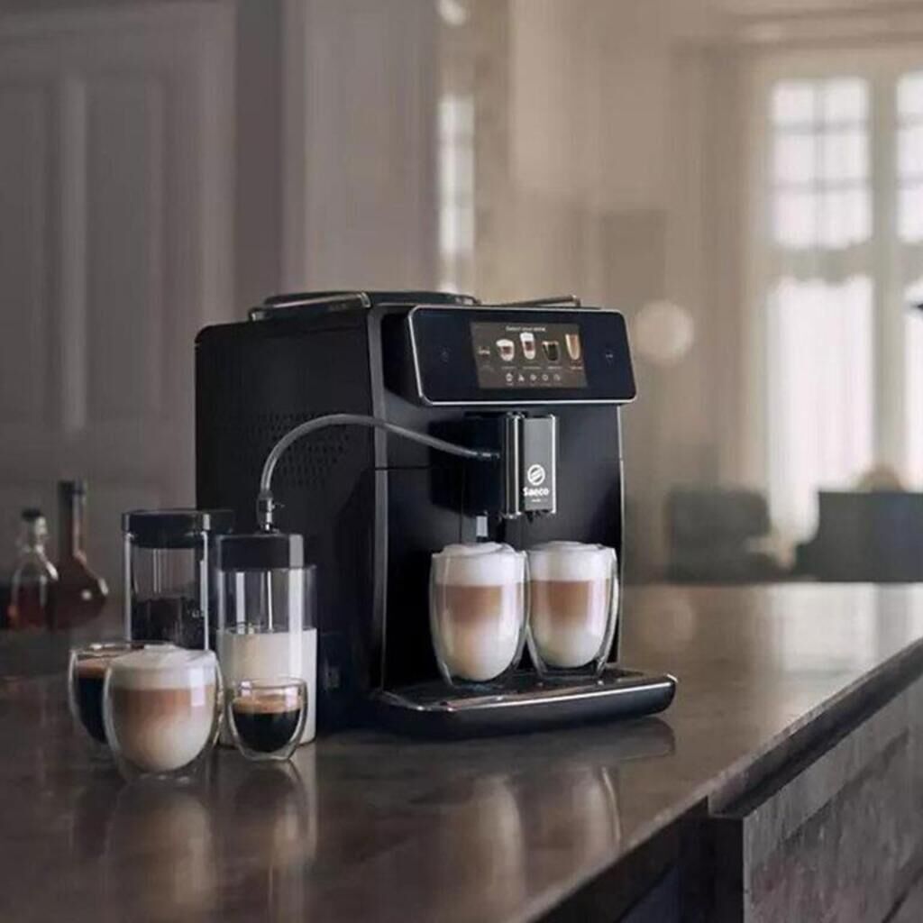 A coffee machine with two cups of coffee on a countertop.