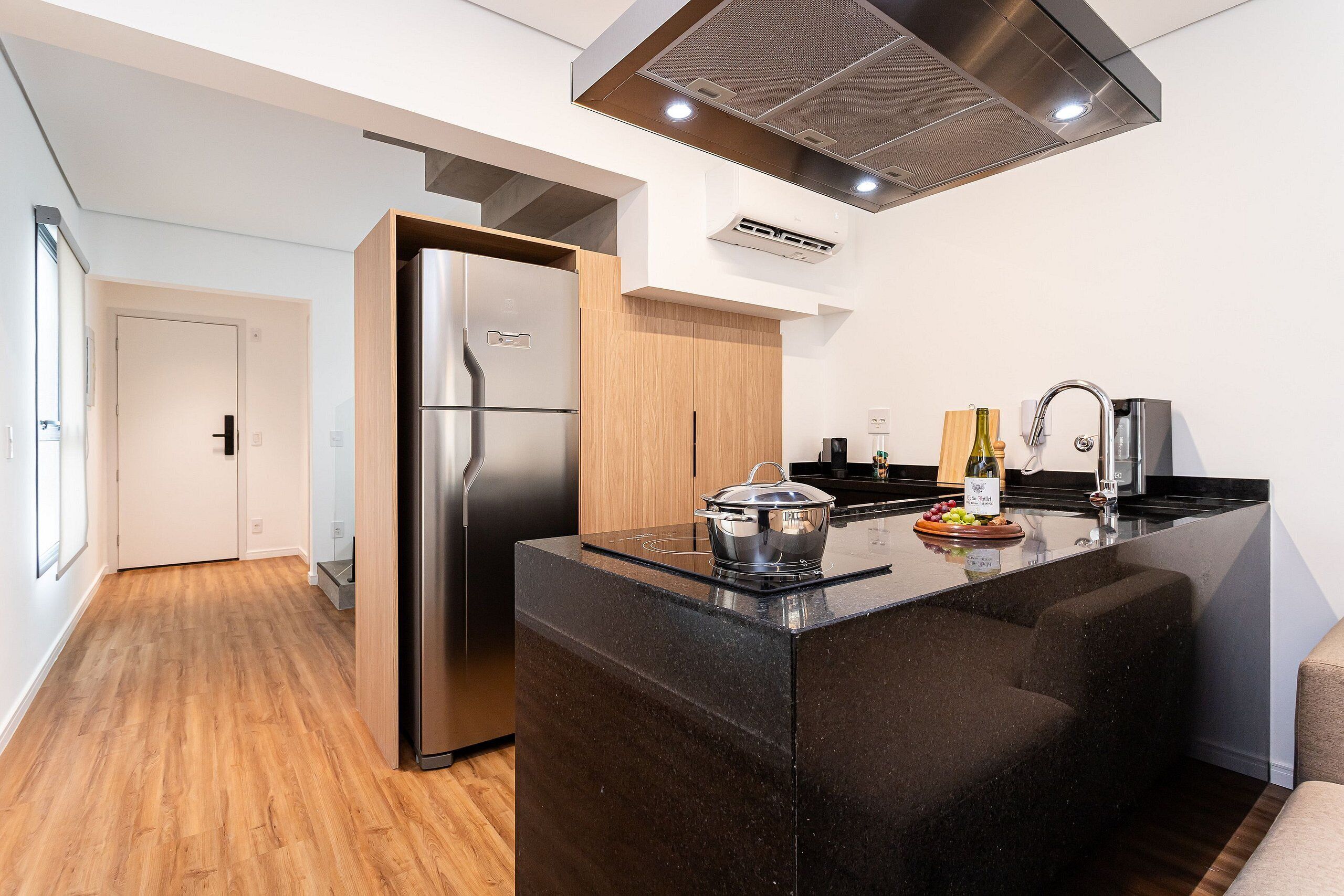 A modern kitchen with a built-in island, stainless steel appliances, and a wooden cabinet.