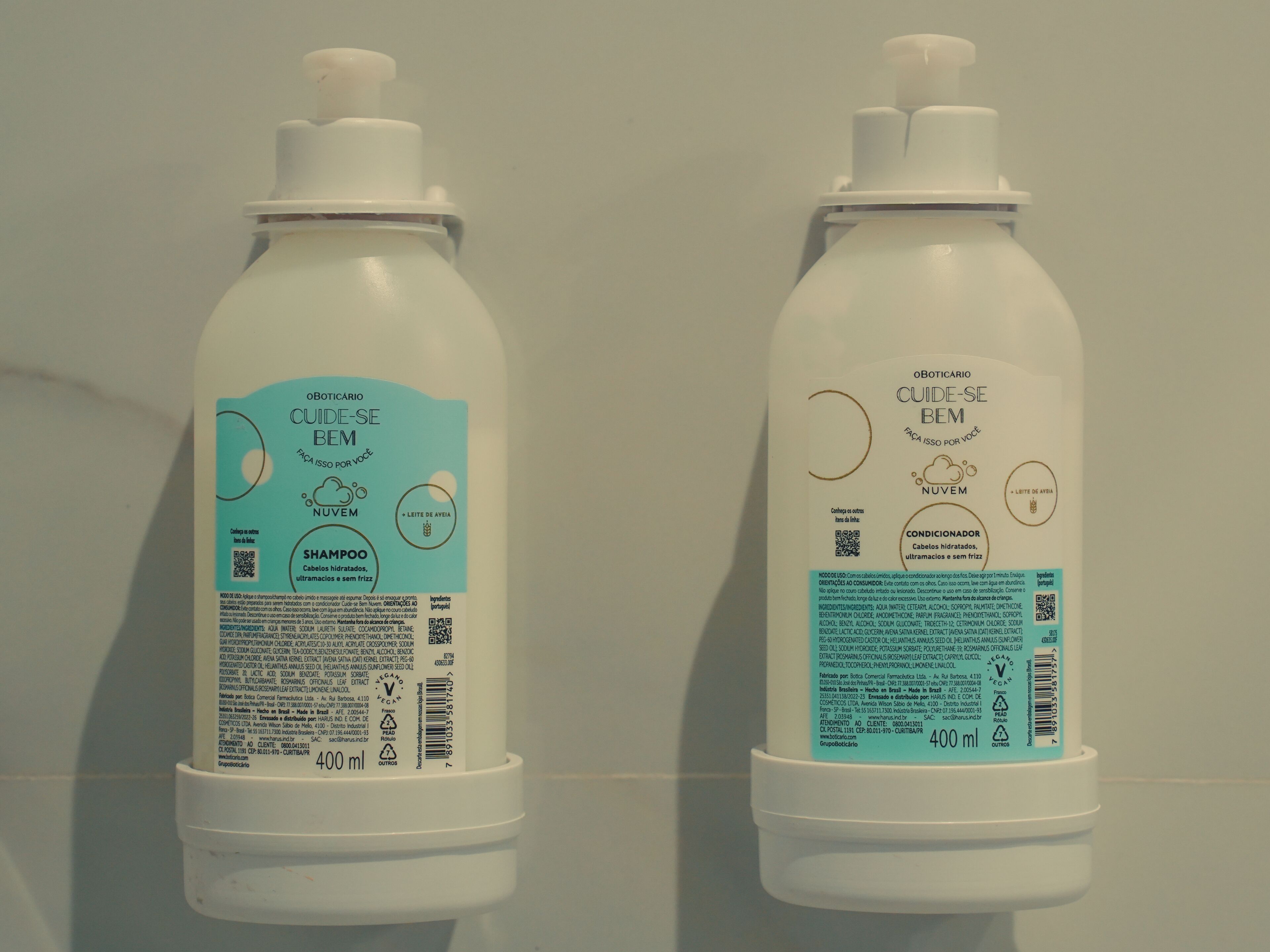 Two white bottles with labels, one labeled 'Shampoo' and the other 'Conditioner,' both with text and QR codes.
