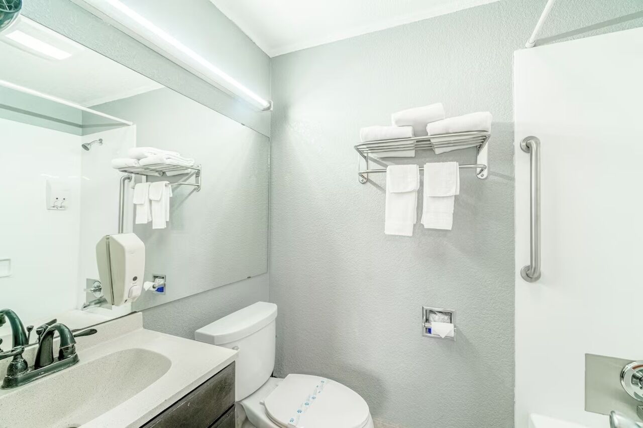 Refresh easily at the well-lit vanity with fluffy towels ready.