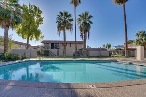 A swimming pool with a fence, palm trees, and a building in the background. - 9 Mi to Downtown Tempe: Condo w/ Pool Access (Tempe)
