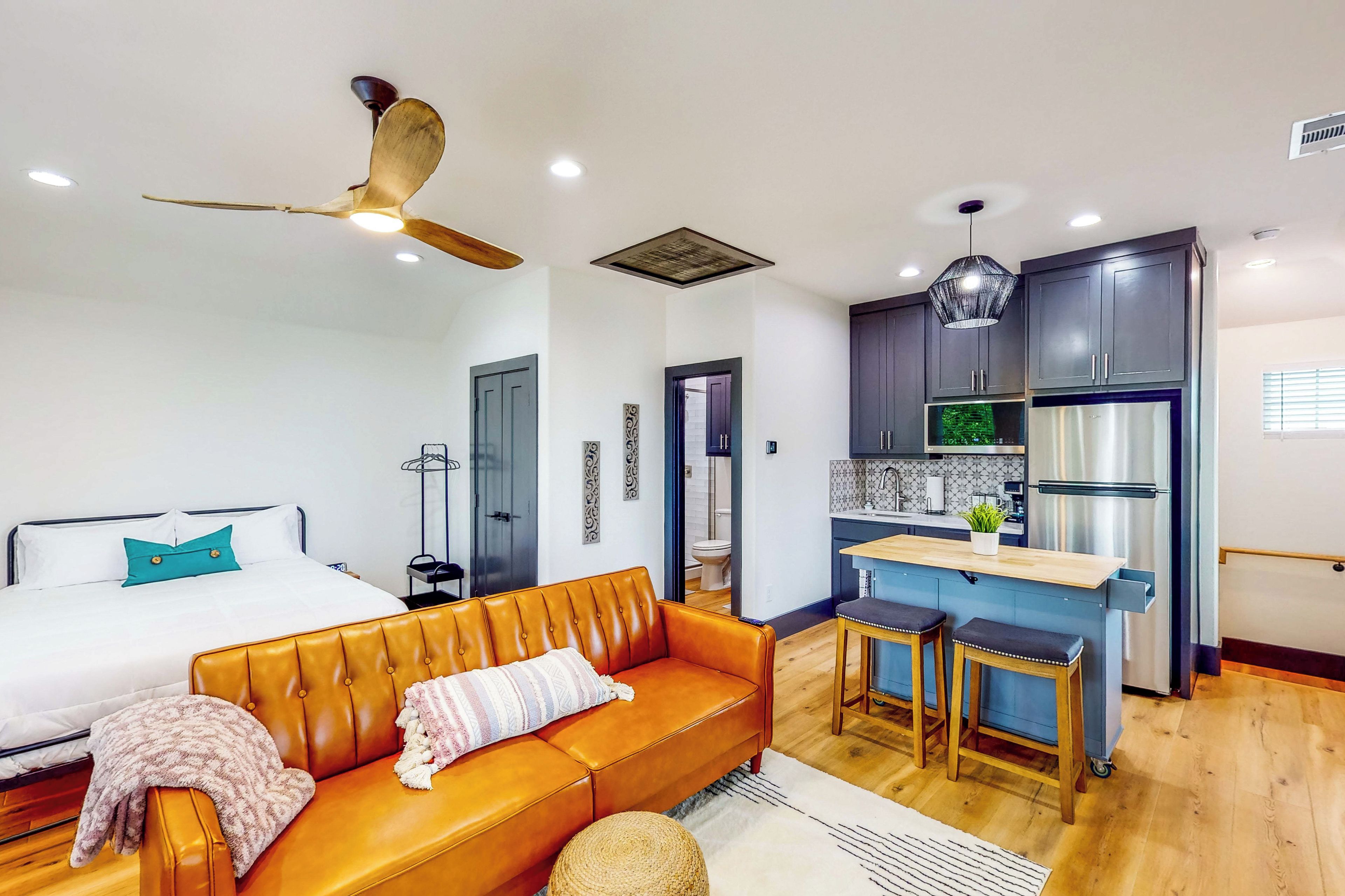 A modern apartment with a living room, bedroom, and kitchen.