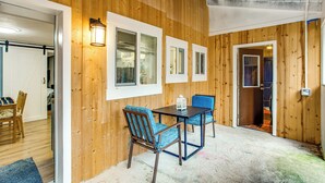A room with wooden walls, a dining table with chairs, and a ceiling fan. - 3 Mi to Puget Sound: Lakefront Gem w/ Patio! (Lakewood)