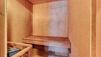A wooden interior with a built-in bench and a small table.