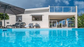 A modern house with a swimming pool, two balconies, and outdoor seating. - Villa Harmony - Four Bedroom Villa, Sleeps 10 (Les Trois-Îlets)