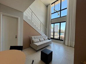 Basic Apartment | Living area | 32-inch Smart TV with digital channels - Full Loft 290 m From the Beach Coe0202 (Florianópolis)