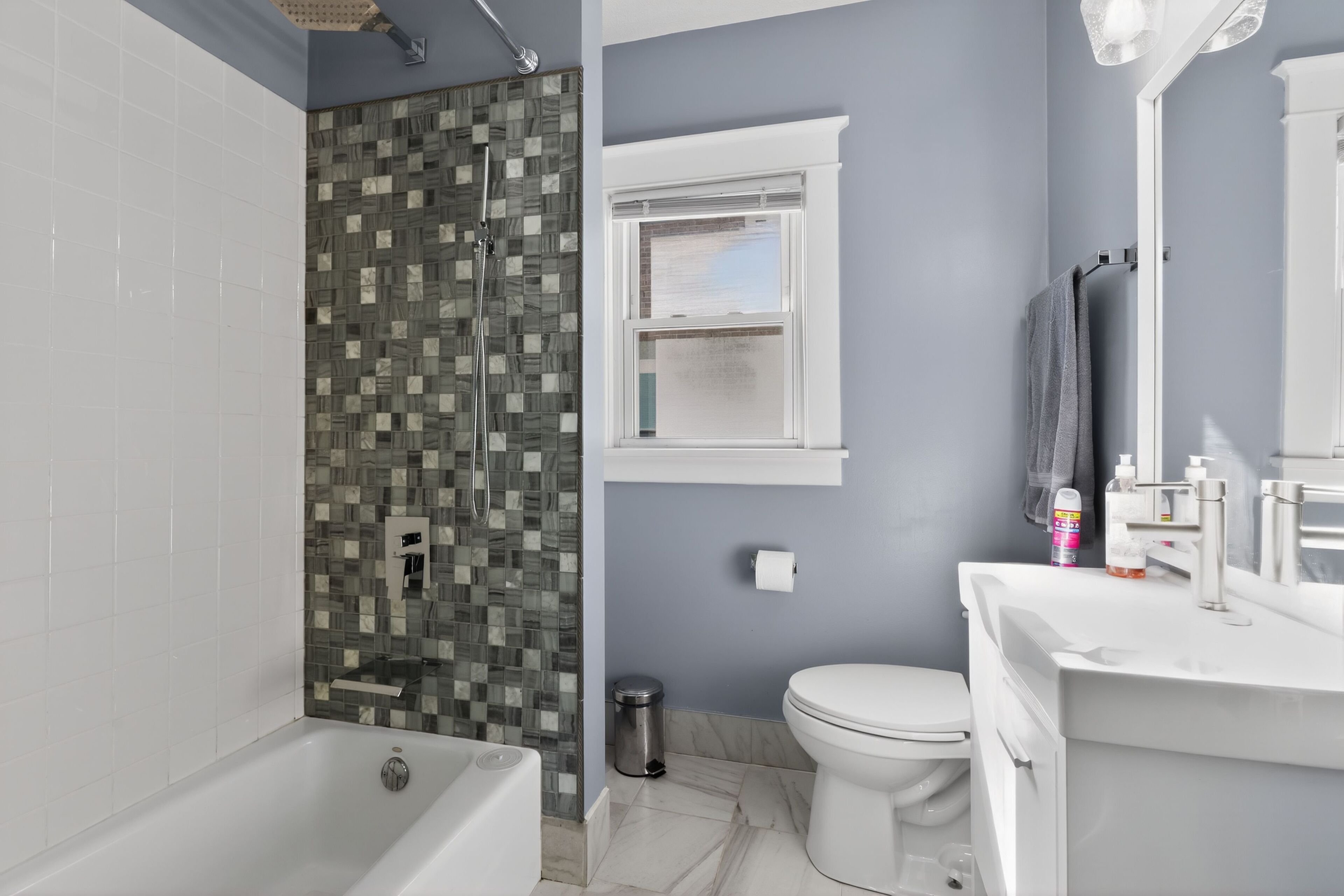A bathroom with a bathtub, a shower, a toilet, and a sink.