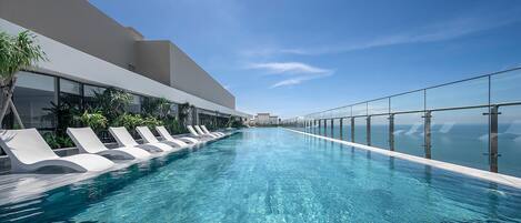 Outdoor pool, pool loungers, lifeguards on site