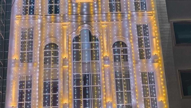 The exterior of the Pacific Prime luxury hotel with illuminated string lights and a prominent entrance. - Hotel Pacific Primee (Zirakpur)