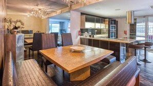 A modern dining area with a marble table, cushioned benches, and a chandelier. - Sea-View Terrace Maisonette, steps from Paceville! (Swieqi)
