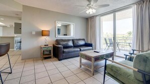 A modern living room with a sofa, a coffee table, and a balcony with a view. - The Barbados | Private Balcony, Pool View! (Key West)