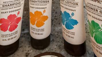 Four bottles of Hawaiian Tropic hair care products and one bar of cleansing soap.