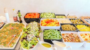 A buffet with various dishes including salads, vegetables, and a tray of food. - Blue&Green Baltic Hotel MediSPA&fit (Kołobrzeg)