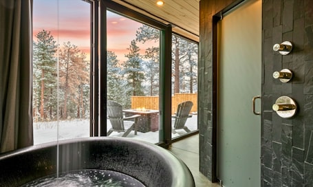 Interior. Private Rammed Earth Cabin: Soaking Tub & Kitchen