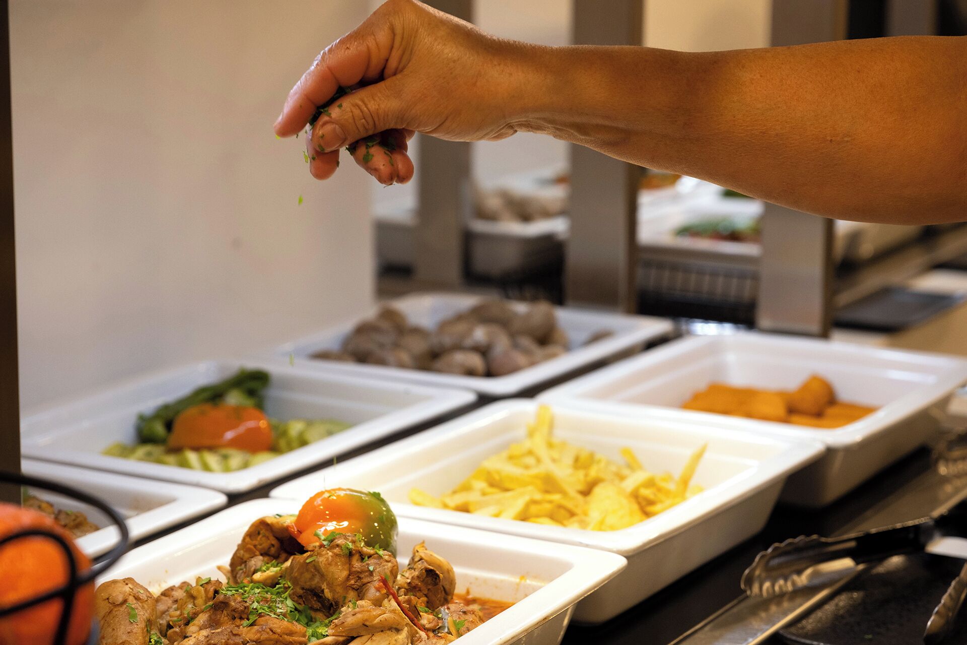 A buffet with various food items in containers.