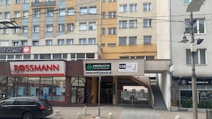 A Rossmann store, a 1-10 star hotel, and a building with a sign for Andrzej Jędrzejczyk. - 110 hostel (Gdynia)