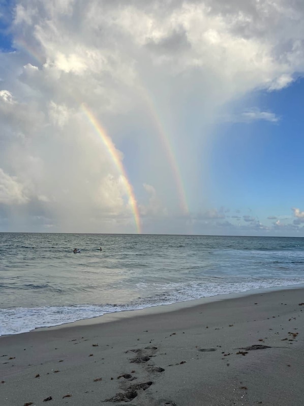 A beach with footprints leading to the water, a clear sky, and a rainbow. - Private Heated Pool-Near Naples Beaches-2BR/2BA (Naples)