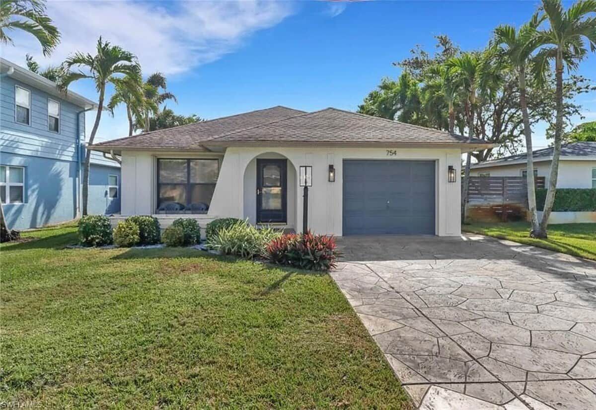A single-story house with a garage, a front lawn, and a driveway.