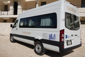 A white van with "Samsara" and "KAL" logos, parked in front of a building with balconies. - Sleeps 6 w Private Rooftop Pool & 2 Bikes (Tulum)