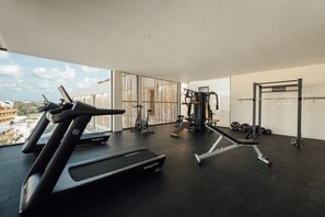 A gym with treadmills, weight machines, and a squat rack. - Sleeps 6 w Private Rooftop Pool & 2 Bikes (Tulum)