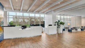 A spacious lobby with a reception desk, seating area, and large windows. - AWESOME Beachfront getaway; 2BR villa in beautiful Marco Island; cool amenities (Marco Island)