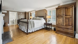 A bedroom with a four-poster bed, wooden wardrobe, and a walk-in closet. - Mayville Union House (Bethel)