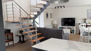 A modern kitchen with a marble countertop, a built-in stove, and a black hanging light fixture. - La Quintana de Pola (Brand-new luxury country retreat in Cudillero) (Cudillero)