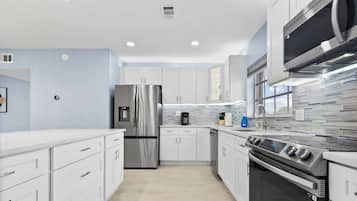Deluxe Condo | Private kitchen | Full-size fridge, microwave, oven, stovetop