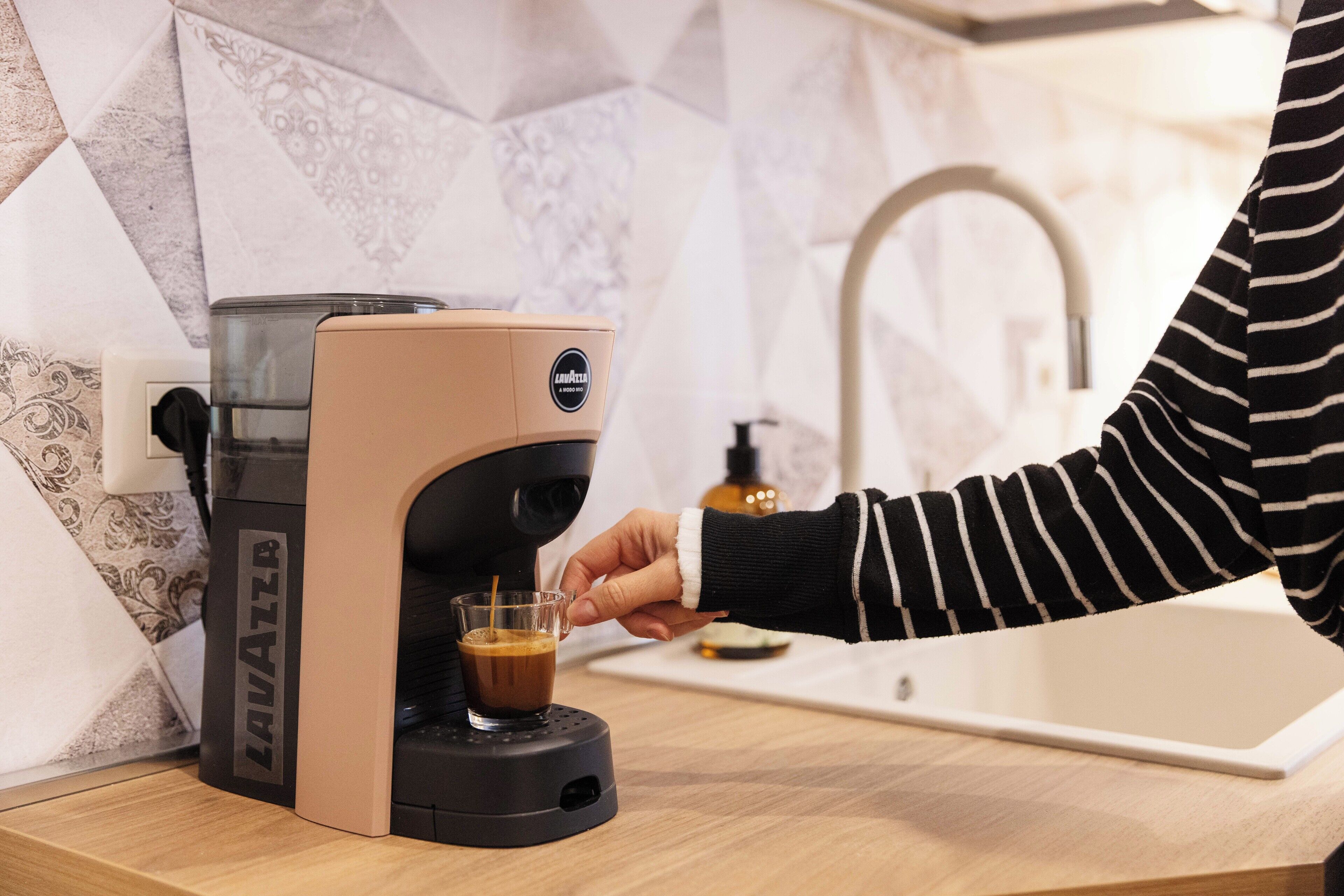 A coffee machine dispensing coffee into a cup.