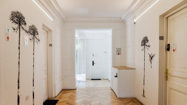 A hallway with white walls, wooden herringbone flooring, and doors numbered 02 and 03. - Cozy Studio Bellavista Dining & Hospital Access (Providencia)
