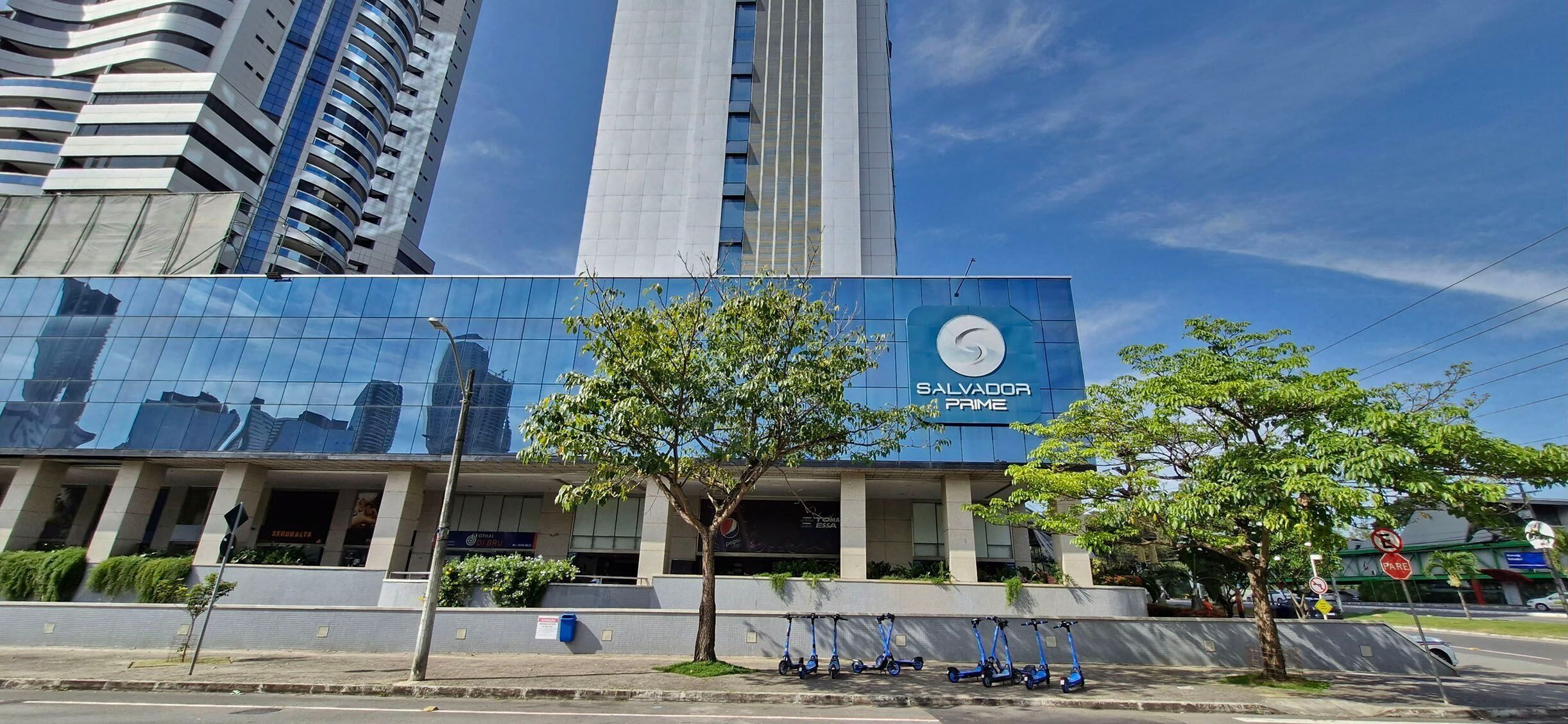 A modern building with a large glass facade and a sign reading "SALYAOOO PRIME".