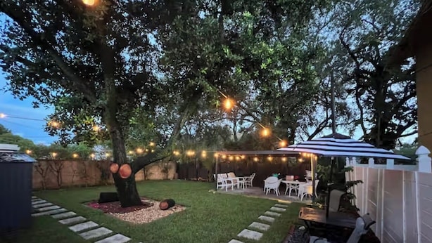 A backyard with a patio area, string lights, a tree, and a barbecue grill. - Wonderful 1-bedroom backyard in Fort Lauderdale (Fort Lauderdale)