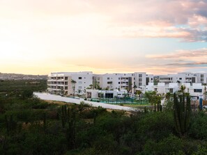 A modern hotel with multiple white buildings, a pool area, and surrounding greenery. - Vista Del Arco - Vista Vela Sunset (Cabo San Lucas)