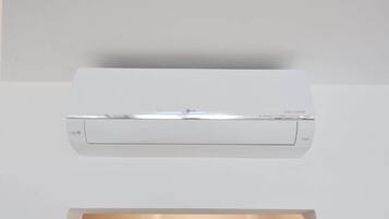 A white air conditioning unit mounted on a ceiling.