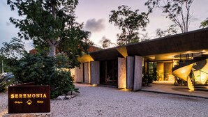 A modern building with a sign reading "SEREMONIA." - Seremonia Origen (Tulum)