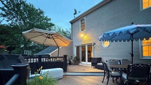 A deck with outdoor furniture, a barbecue grill, and a covered patio area. - WORLD CUP LUXE–Walk to Train+Heated Pool & Spa-20 Min to Newark Airport-Sleep 10 (New Providence)