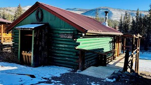 A rustic log cabin with a green exterior and a red roof, labeled "Little Red." - Great mountain cabin with river views. Sleeps 4. 15 miles to Wolf Creek Ski area and 3/4 mile private fishing. (South Fork)
