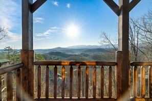 A wooden deck with a view of a mountainous landscape. - Sevierville Views • Hot Tub • Theater • Pets OK (Sevierville)