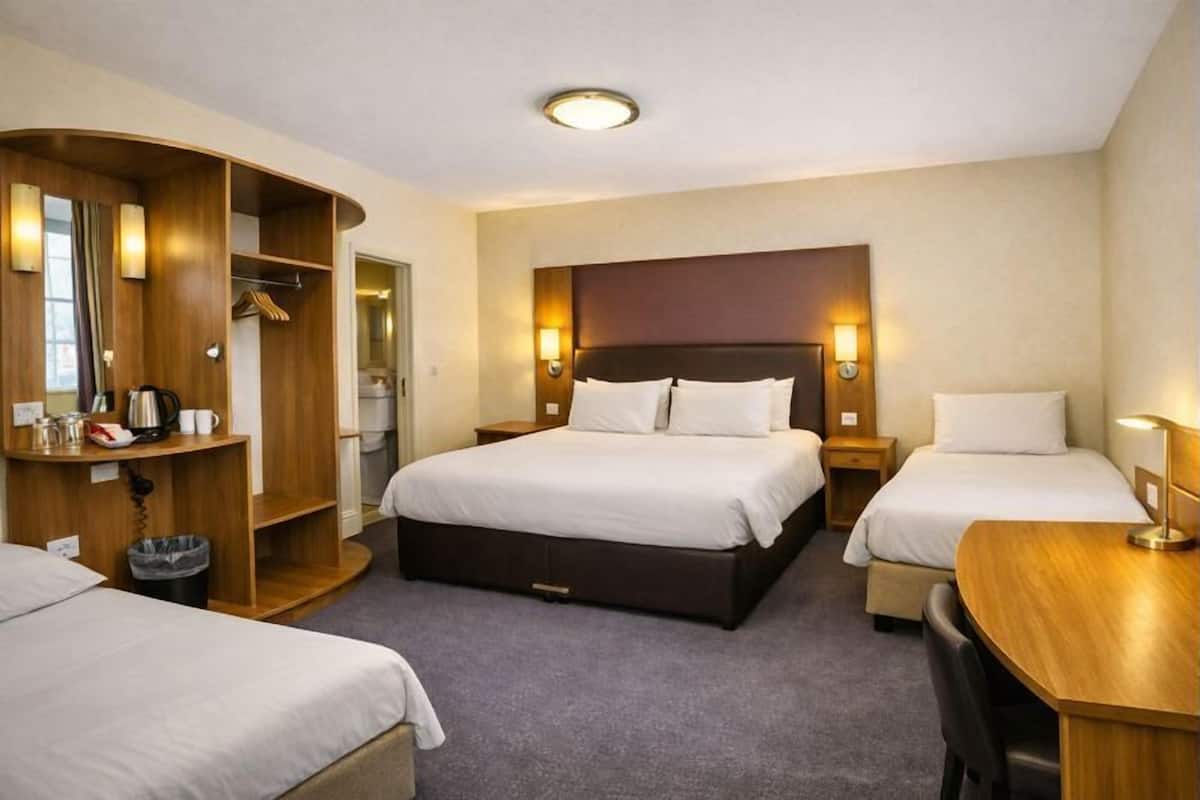 Deluxe Quadruple Room | Desk, laptop workspace, iron/ironing board