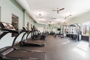A gym with treadmills, stationary bikes, and weightlifting equipment.