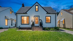 A two-story house with a front porch, a visible number '5252' on the door, and a well-maintained lawn. - HotTub|Game Room|Air Hockey|Nintendo Wii|Sleeps 8 (Parma)