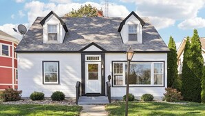 A two-story house with a central entrance, a small porch, and a satellite dish. - Church Street Retreat - Downtown Location! (Wisconsin Dells)