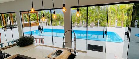 Honeymoon Cabin, Jetted Tub, Pool View | Private kitchen | Dining tables