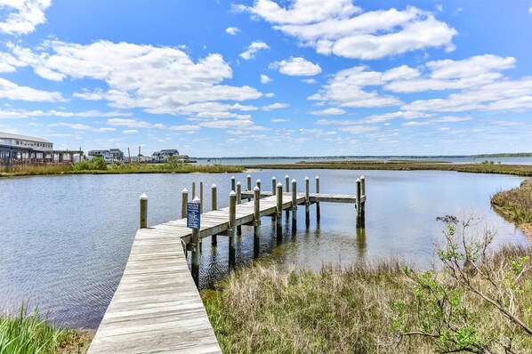 A wooden pier extending into calm water with a clear sky above. - Two Bedroom Updated Condo with Great Amenities (Ocean City)